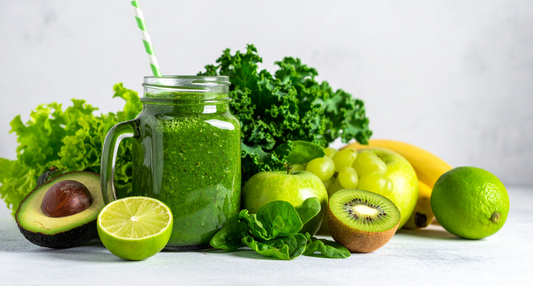 A vibrant, creamy Green Machine Smoothie in a glass, surrounded by fresh kale and spinach leaves harvested from a Seasonal Garden Kit.