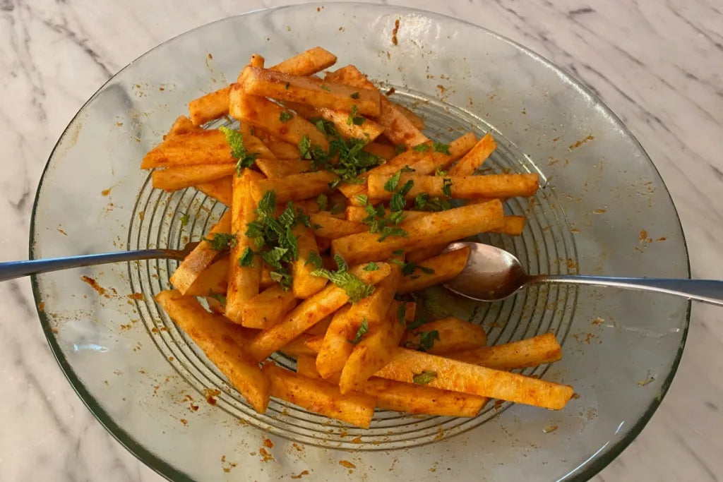 fresh jicama fries with herbs on top