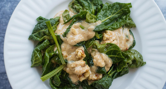 A plate of vibrant Sautéed Swiss Chard with Miso walnut sauce, featuring colorful stems and toasted walnuts, inspired by a Seasonal Garden Kit harvest.